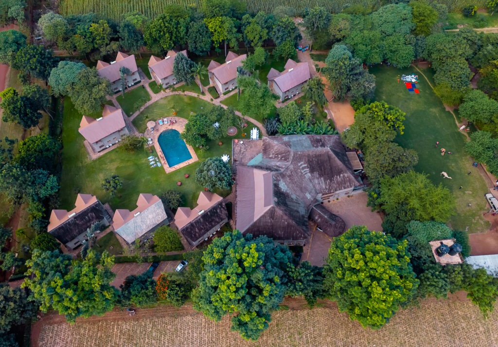 Aerial view of Weruweru River Lodge nestled beside the Weruweru River with Mount Kilimanjaro in the background, Moshi, Tanzania