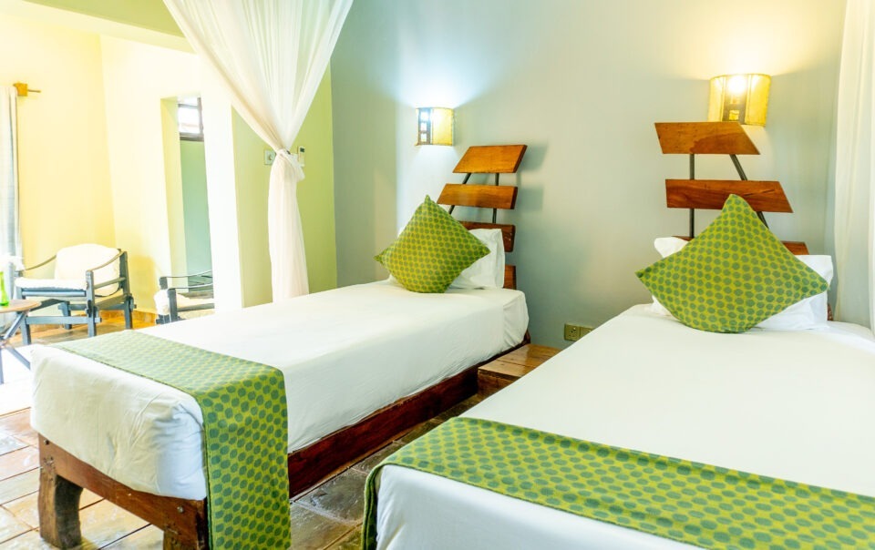 Twin room with garden-facing windows at Weruweru River Lodge, Moshi Tanzania